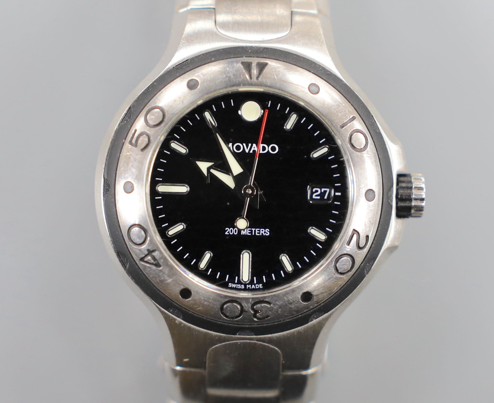 A lady's modern stainless steel Movado quartz wrist watch, on a stainless steel Movado bracelet, with box.